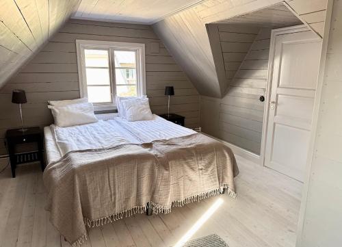 a bedroom with a large bed in a attic at Newly renovated 2 bedroom apartment in Visby