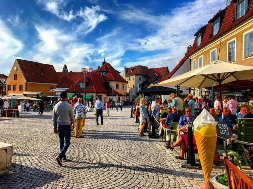 a group of people walking down a street at Newly renovated 2 bedroom apartment in Visby