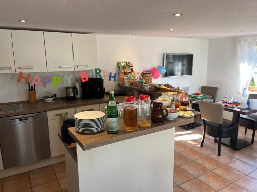 a kitchen with a happy birthday sign on a counter at Pension Hinter der Düne in Juliusruh
