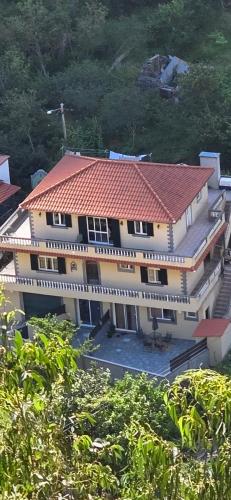 an aerial view of a house with a red roof at Danny's Rural Suite T1 in Curral das Freiras