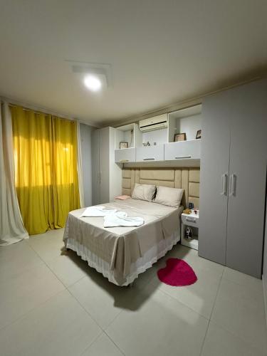 a bedroom with a large bed and a red rug at Nossa Casa de férias em Alter do Chão in Alter do Chao
