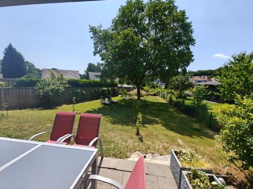 a view of a yard with two chairs and a table at Ferienhaus Oebel in Brüggen in Brüggen