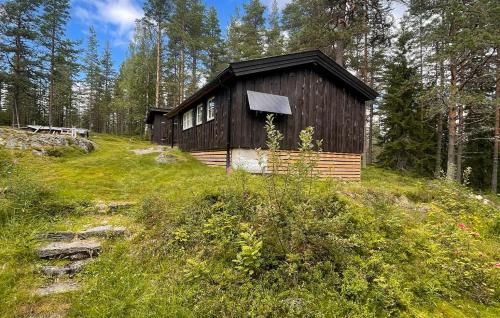 a small cabin on a hill in the woods at Holmsjøhytta in Sjørbotn