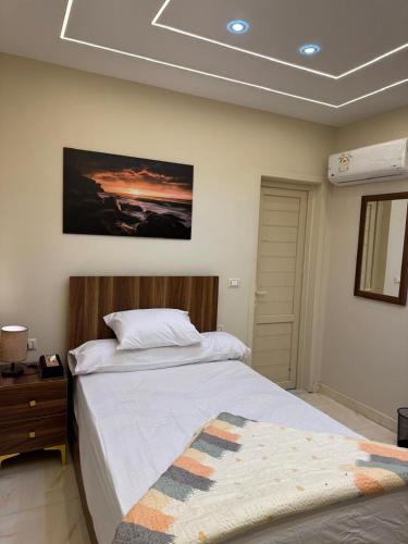 a bedroom with a bed and a picture on the wall at Pyramids Green View in Cairo