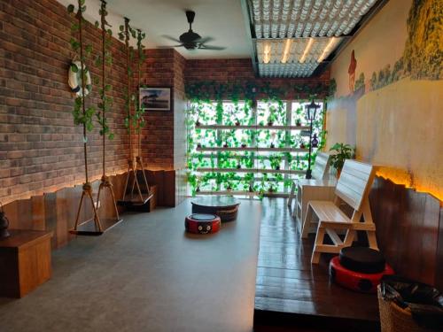 a living room with a brick wall and a table and bench at Sekinchan PaddyCruise Homestay Wifi in Sekincan