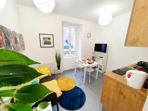 un soggiorno con scrivania, tavolo e tavolo di Le binic - proche gare et centre a Saint-Brieuc