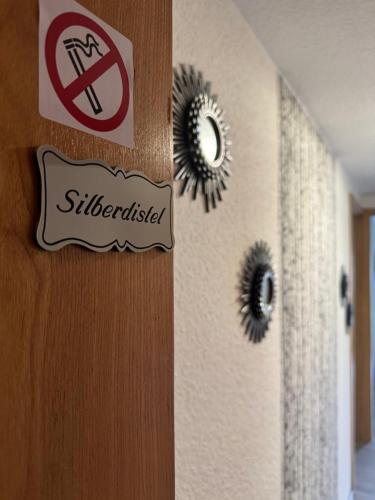 a door with a no smoking sign and two mirrors at Altmarkblick in Erbenhausen