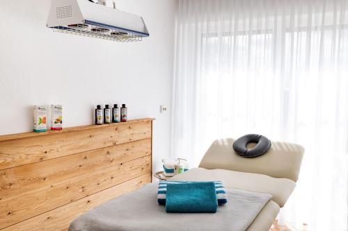 a living room with a chair and a window at Apart Hotel am Sonnenhügel in Bad Birnbach