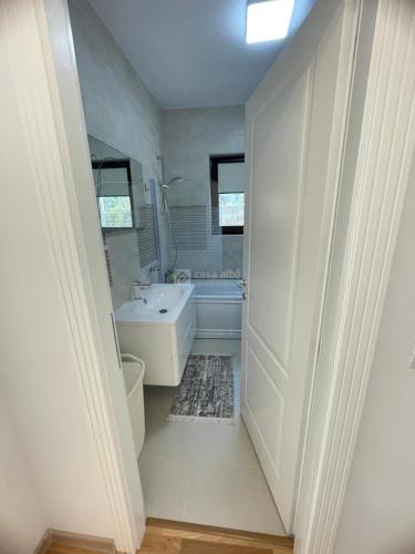 a bathroom with a tub and a toilet and a sink at Vila Premium Iasi in Iaşi