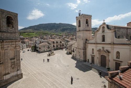 a view of a town with a church and a street at Casetta in piazza in Palazzo Adriano