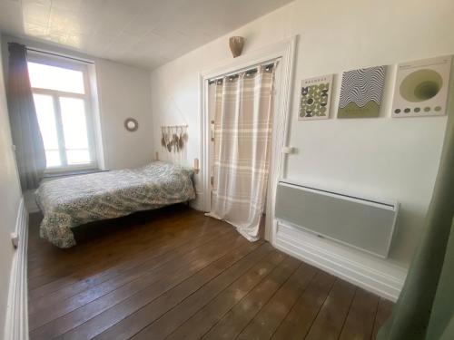 a small room with a bed and a window at Appart au cœur du dernier sou in Boulogne-sur-Mer