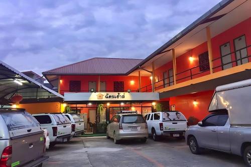 a parking lot in front of a car dealership at Chat House Chiang Rai in Chiang Rai