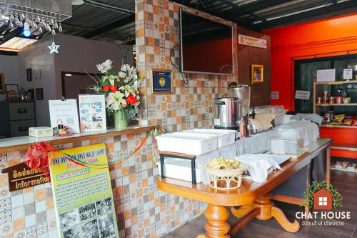 a counter in a restaurant with a counter sidx sidx sidx at Chat House Chiang Rai in Chiang Rai