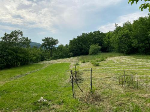 a field with a fence in the grass at Vila Dolina in Hum