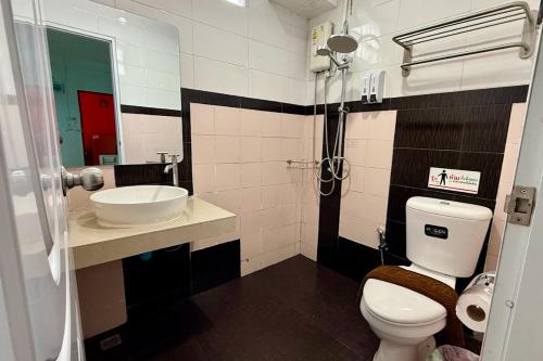 a bathroom with a toilet and a sink at Chat House Chiang Rai in Chiang Rai