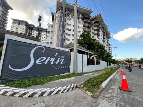 a sign on the side of a street with orange cones at The Nook Cabin in Tagaytay