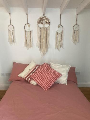 a bedroom with a bed with pillows on it at Hidden Gem in cullercoats in Cullercoats
