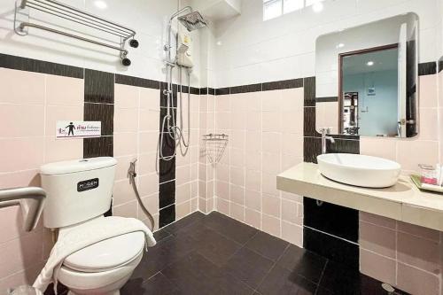 a bathroom with a toilet and a sink at Chat House Chiang Rai in Chiang Rai