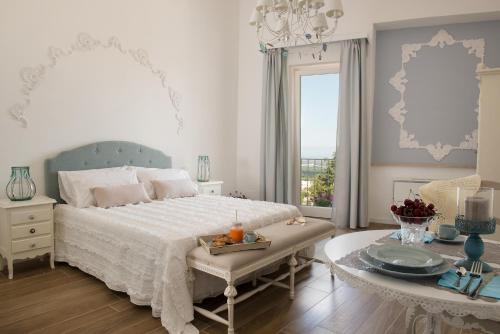 a bedroom with a bed and a table with a tray of food at Biancadamare in Ostuni