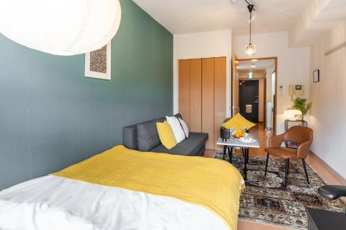 a bedroom with a bed and a couch at Koubun Room Yokohama Hiyoshi Vacation Rental in Yokohama