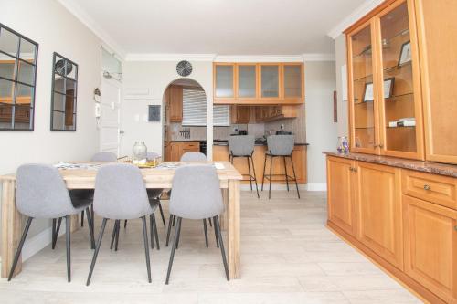 a kitchen and dining room with a table and chairs at 64 Sea Lodge Umhlanga Rocks in Durban