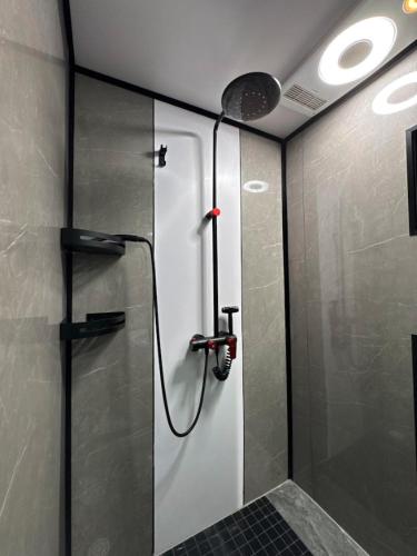 a shower with a glass door in a bathroom at Pousada Ilha Canela in Palmas