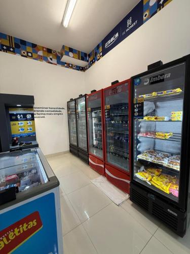 a store with two refrigerators in a grocery store at Flat Praia Luxury Century in Vitória