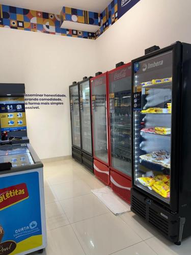 a store with two refrigerators with food inside of it at Flat Praia Luxury Century in Vitória