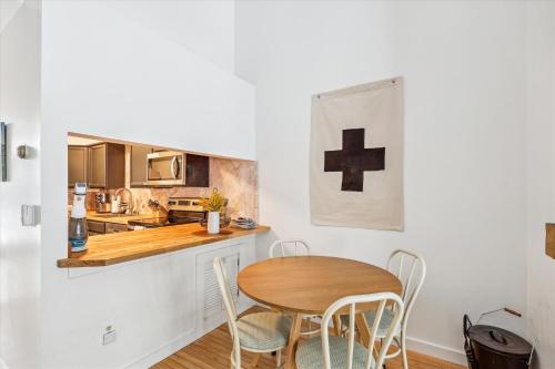 a small kitchen with a wooden table and chairs at Riverside Getaway in Stowe