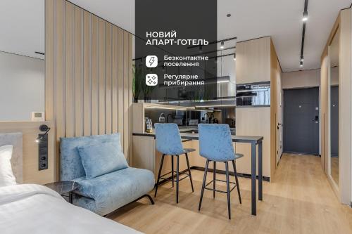 a bedroom with a bed and a table and chairs at Manhattan High Line Apart in Kyiv