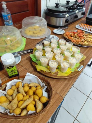 a table with three plates of food on it at Ponta Negra Suites & Apart in Natal