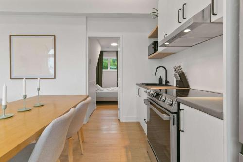 a kitchen with a counter and a table and chairs at Elska - SPA and Mountain in Saint Come