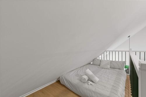 a white bedroom with a bed in the attic at Elska - SPA and Mountain in Saint Come