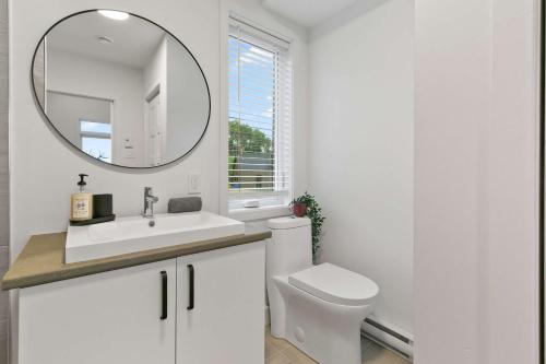 a white bathroom with a toilet and a mirror at Elska - SPA and Mountain in Saint Come