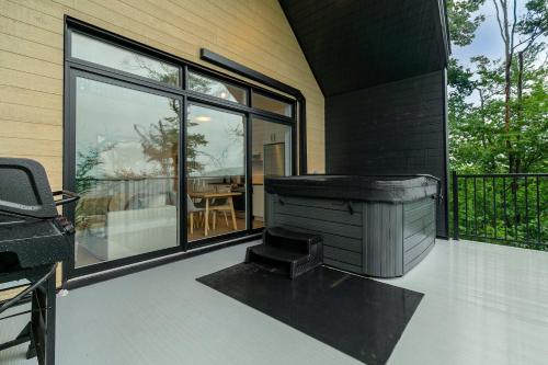 a house with a jacuzzi on a patio at Elska - SPA and Mountain in Saint Come