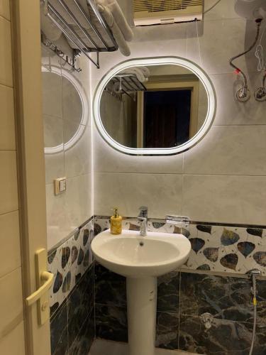 a bathroom with a sink and a mirror at Pyramids Green View in Cairo
