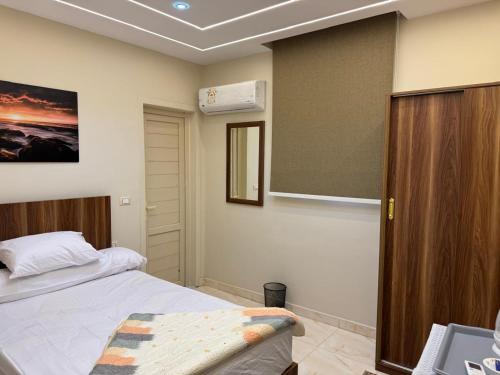 a bedroom with a bed and a air conditioner at Pyramids Green View in Cairo