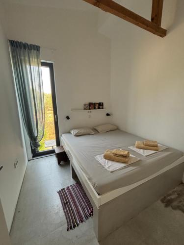 a bedroom with a bed with two towels on it at Modern Summer House Popi in Pálioura