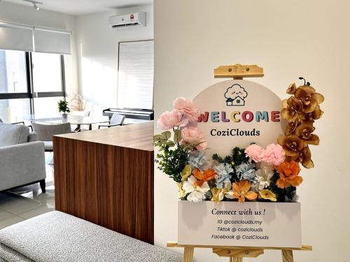 a welcome sign in a room with flowers and balloons at NEW Designer Condo - Panoramic Forest View - Steps To IOI City Mall - Your Best Urban Retreat in Putrajaya