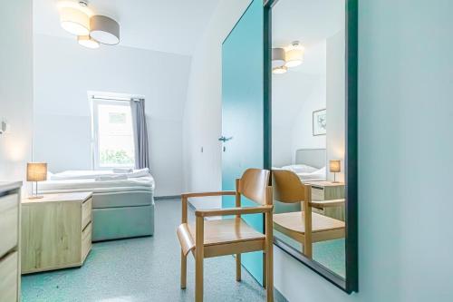 a room with a mirror and a table and chair at Hotel Astral Vienna in Vienna