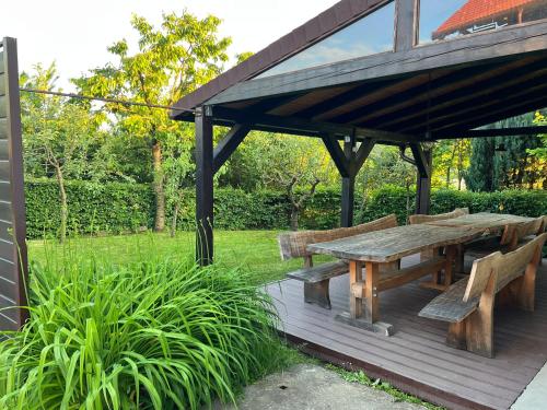 a wooden picnic table and benches on a deck at IDa House in Sveti Ivan Zelina