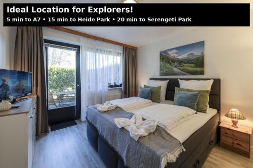 a bedroom with a large bed in front of a window at AMAYA SUITES nahe Heide Park, Serengeti Park & A7 in Soltau