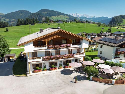an aerial view of a hotel with tables and umbrellas at Embacherhof in Embach