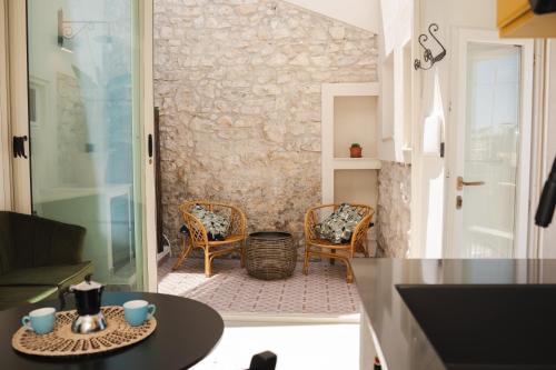 a kitchen with a table and chairs in a room at Casa Cucunci in Modica