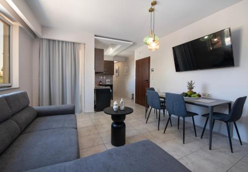 a living room with a couch and a table at United Cretan Villas in Agia Marina Nea Kydonias