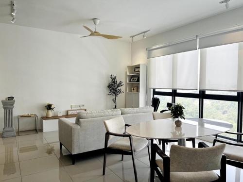 a living room with a couch and a table at NEW Designer Condo - Panoramic Forest View - Steps To IOI City Mall - Your Best Urban Retreat in Putrajaya