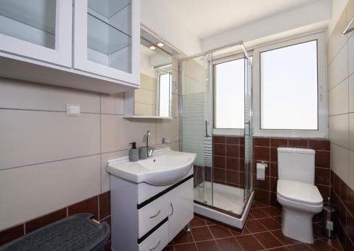 a bathroom with a sink and a toilet at United Cretan Villas in Agia Marina Nea Kydonias