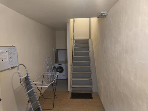 a room with a staircase leading to a room at Appartement 75m2 - Centre-ville in Parthenay