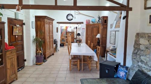 a dining room with a table and some chairs at Chambres D'hôtes Le Bellevue - in Montbrun-les-Bains