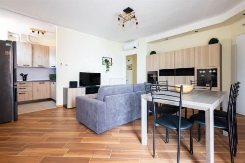 a kitchen and living room with a table and a couch at IseoLakeRental - Fuori Porta in Tavernola Bergamasca